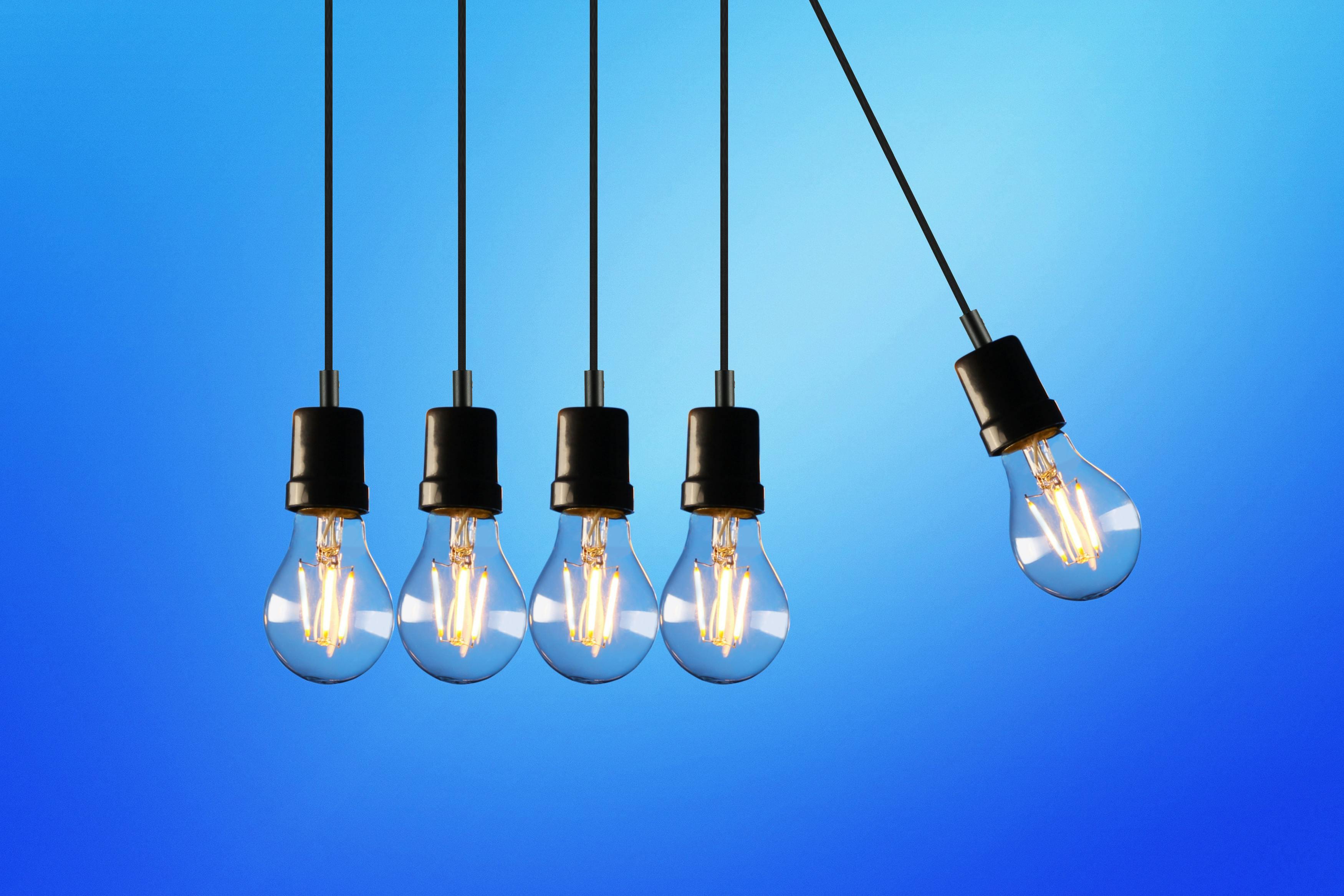 Light bulbs hanging together against a blue background 