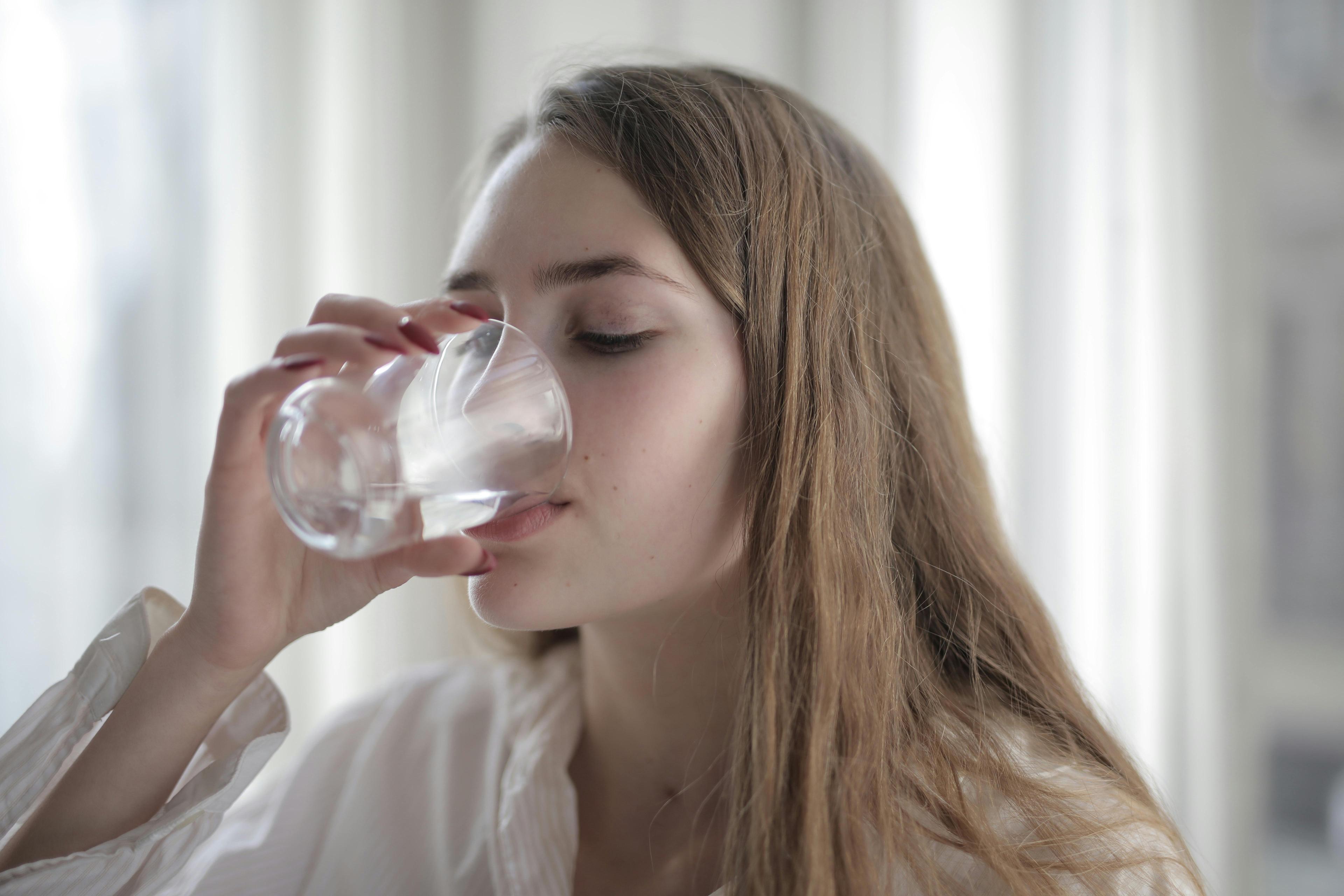 woman drinking a glass of water